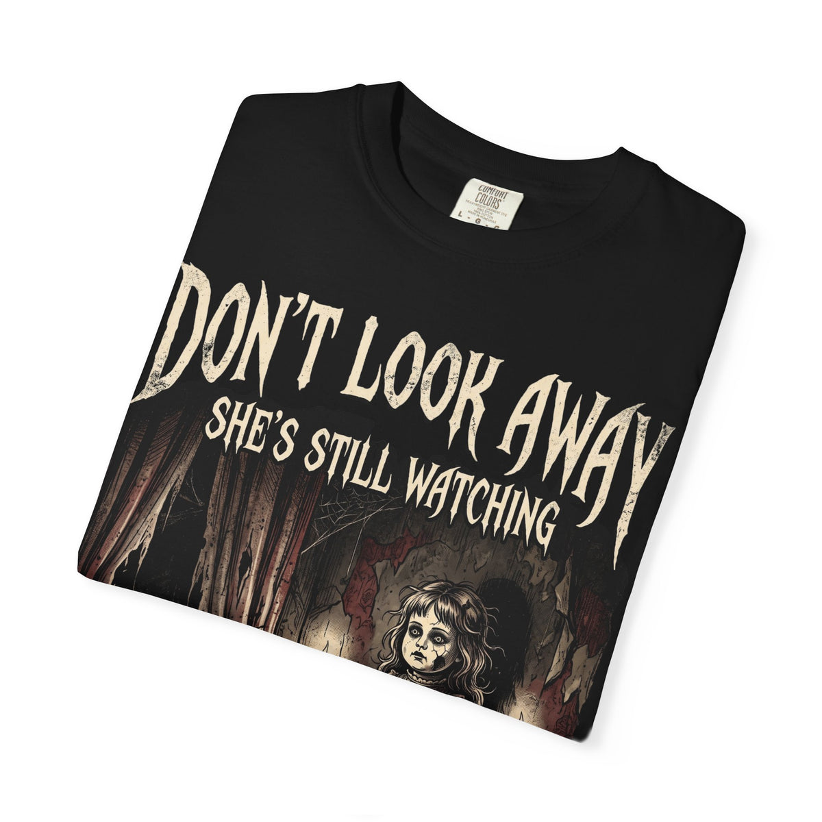 Horror Tee — "Don't Look Away, She's Still Watching" Creepy Doll Graphic T-Shirt