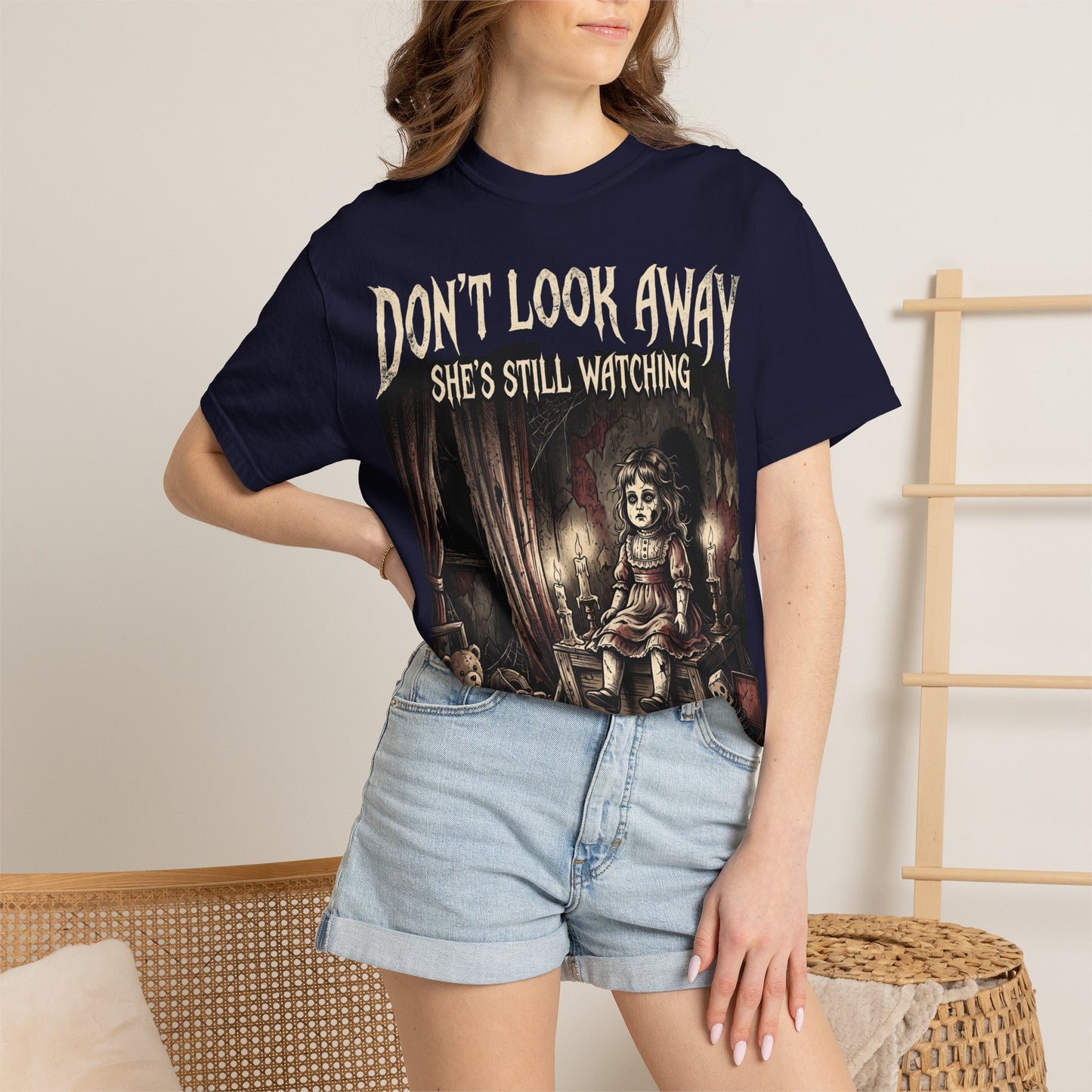 Horror Tee — "Don't Look Away, She's Still Watching" Creepy Doll Graphic T-Shirt