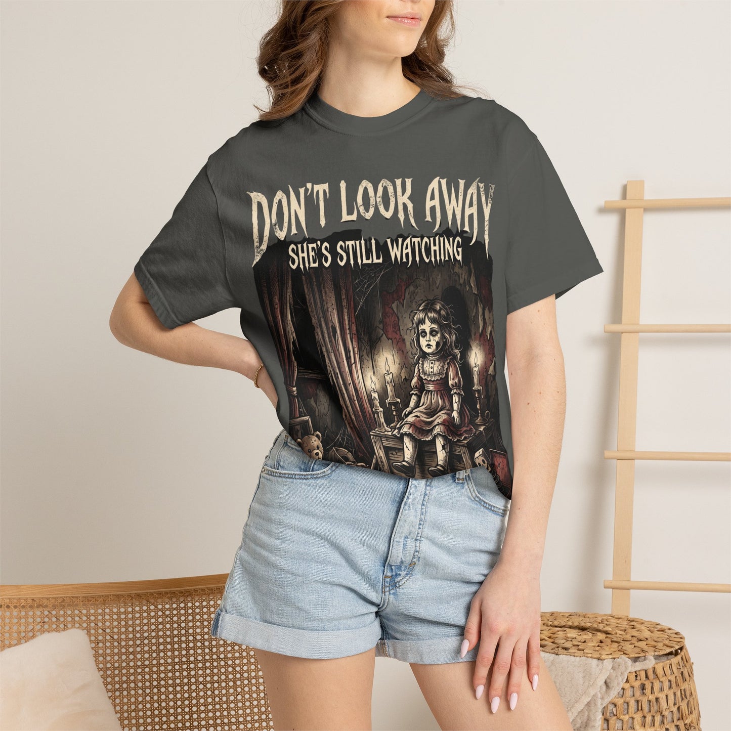 Horror Tee — "Don't Look Away, She's Still Watching" Creepy Doll Graphic T-Shirt