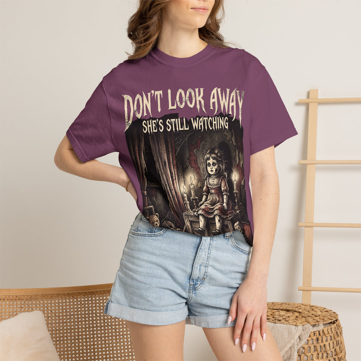 Horror Tee — "Don't Look Away, She's Still Watching" Creepy Doll Graphic T-Shirt