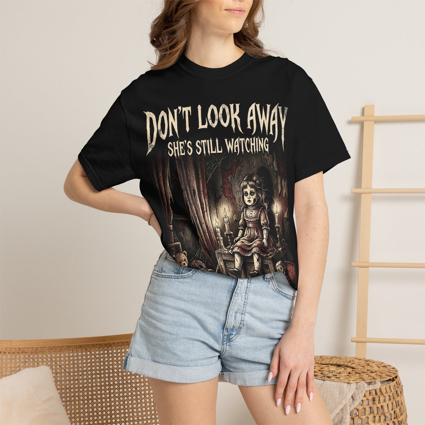 Horror Tee — "Don't Look Away, She's Still Watching" Creepy Doll Graphic T-Shirt