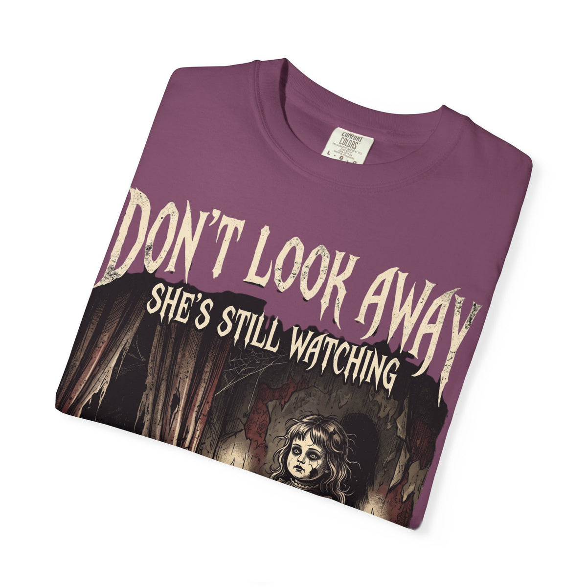 Horror Tee — "Don't Look Away, She's Still Watching" Creepy Doll Graphic T-Shirt